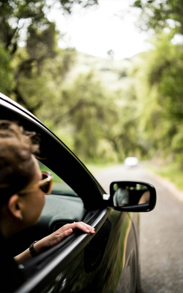 person in car enjoying a drive during the West Michigan summer